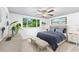 Cozy bedroom with a plush bed, neutral tones, and a large window offering natural light and green views at 996 56Th S Ave, St Petersburg, FL 33705