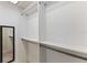 Organized walk-in closet with built-in shelves and hanging rods and mirror at 996 56Th S Ave, St Petersburg, FL 33705