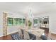 Elegant dining room with a large window, crystal chandelier, and view into the adjacent living space at 996 56Th S Ave, St Petersburg, FL 33705