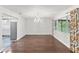 Elegant dining room featuring hardwood floors, a crystal chandelier and large windows at 996 56Th S Ave, St Petersburg, FL 33705