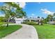 Charming two-story home with a well-maintained lawn and a winding driveway at 996 56Th S Ave, St Petersburg, FL 33705
