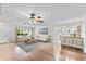 Bright, open living room featuring hardwood floors, stylish furnishings, and seamless flow to the kitchen area at 996 56Th S Ave, St Petersburg, FL 33705