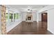 Spacious living room with a stone fireplace, hardwood floors, and large windows at 996 56Th S Ave, St Petersburg, FL 33705