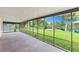 Spacious screened-in porch providing relaxing views of the lush backyard and tranquil lake at 996 56Th S Ave, St Petersburg, FL 33705