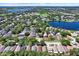 An aerial shot of homes in a lakeside community with mature trees and lake views on a sunny day at 10401 Lakeside Vista Dr, Riverview, FL 33569