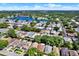 Expansive aerial view of a lakeside community with tree-lined streets, single-Gathering homes, and a tranquil lake at 10401 Lakeside Vista Dr, Riverview, FL 33569