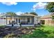 View of the home's screened-in porch and well-maintained backyard, great for outdoor enjoyment at 10401 Lakeside Vista Dr, Riverview, FL 33569