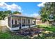 Beautiful backyard showcasing a covered patio, lawn, and lush landscaping at 10401 Lakeside Vista Dr, Riverview, FL 33569