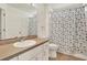 Clean bathroom with vanity, toilet, and shower featuring a butterfly-themed curtain at 10401 Lakeside Vista Dr, Riverview, FL 33569