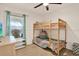 A bedroom includes wood floors, a bunkbed and lots of natural light at 10401 Lakeside Vista Dr, Riverview, FL 33569