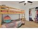 A bedroom has a bunkbed, wood floors and closet space at 10401 Lakeside Vista Dr, Riverview, FL 33569