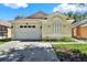 Charming one-story home featuring a two-car garage, well-maintained lawn and garden and neutral paint scheme at 10401 Lakeside Vista Dr, Riverview, FL 33569