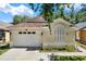 Charming single-story home featuring an attached two-car garage and well-maintained landscaping at 10401 Lakeside Vista Dr, Riverview, FL 33569