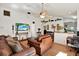 Bright living room with hard wood floors, ceiling fan, and view to kitchen with bar top at 10401 Lakeside Vista Dr, Riverview, FL 33569