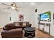 Cozy living room featuring hardwood floors, and a television for easy viewing at 10401 Lakeside Vista Dr, Riverview, FL 33569