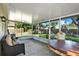 Enclosed patio space with seating, a large table, and views of the backyard at 10401 Lakeside Vista Dr, Riverview, FL 33569