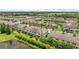 Aerial view of community townhomes, landscaping, and a nearby lake at 11526 Crowned Sparrow Ln, Tampa, FL 33626