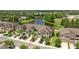 Aerial view of the community, featuring townhomes and a lake at 11526 Crowned Sparrow Ln, Tampa, FL 33626