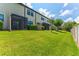 Well-manicured backyard featuring healthy green grass and landscaping at 11526 Crowned Sparrow Ln, Tampa, FL 33626