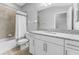 Bathroom with modern fixtures, granite countertops, bathtub and tiled shower, and tiled floor at 11526 Crowned Sparrow Ln, Tampa, FL 33626