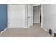 Bedroom features a closet, neutral carpet, and a view into the hallway at 11526 Crowned Sparrow Ln, Tampa, FL 33626