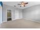 Bedroom with carpet, ceiling fan, and ensuite bathroom with glass enclosed shower at 11526 Crowned Sparrow Ln, Tampa, FL 33626