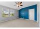 Bedroom with gray walls, carpet, a ceiling fan, and natural light from the two windows at 11526 Crowned Sparrow Ln, Tampa, FL 33626