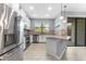 Modern kitchen featuring stainless steel appliances, granite countertops, and a stylish tile backsplash with natural light at 11526 Crowned Sparrow Ln, Tampa, FL 33626