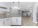 Open-concept living space showcasing a kitchen with granite countertops, tile floors, and gray walls at 11526 Crowned Sparrow Ln, Tampa, FL 33626
