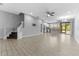 Open-concept living room featuring tile floors, gray walls, and a staircase leading to the second floor at 11526 Crowned Sparrow Ln, Tampa, FL 33626