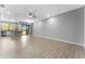 Large living room with tile floors, ample space, and modern lighting fixtures, perfect for entertaining guests at 11526 Crowned Sparrow Ln, Tampa, FL 33626