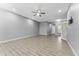 Spacious living room showcasing tile floors, neutral gray walls, and recessed lighting at 11526 Crowned Sparrow Ln, Tampa, FL 33626