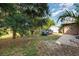 Spacious backyard featuring mature trees and a storage shed on a neatly kept property at 1162 Music Ln, North Port, FL 34286