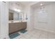 Bright bathroom with double sink vanity, nautical decor, tiled floor, and window at 1162 Music Ln, North Port, FL 34286