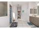 Bright bathroom featuring tiled floors, a glass enclosed shower, and vanity with sink at 1162 Music Ln, North Port, FL 34286