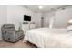 Comfortable carpeted bedroom with closet, dresser, ceiling fan, and comfortable seating at 1162 Music Ln, North Port, FL 34286