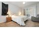 Cozy bedroom with a comfortable queen-size bed, a ceiling fan, and access to a private patio at 1162 Music Ln, North Port, FL 34286