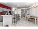 Kitchen with barstool seating at the counter, gray cabinetry and stainless steel appliances at 1162 Music Ln, North Port, FL 34286