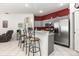 Kitchen with barstool seating at the counter, gray cabinetry and stainless steel appliances at 1162 Music Ln, North Port, FL 34286