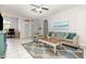 Bright living room with tile floors, comfortable seating, a modern rug, and an open layout at 1162 Music Ln, North Port, FL 34286