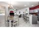 Bright living room featuring tile floors, comfortable seating, dinette and partial kitchen view at 1162 Music Ln, North Port, FL 34286