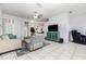 Bright living room featuring tile floors, comfortable seating, and entertainment center at 1162 Music Ln, North Port, FL 34286