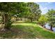 The property features a spacious backyard with mature trees and access to a serene pond at 11638 Branch Mooring Dr, Tampa, FL 33635