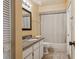 Well-lit bathroom featuring a granite countertop, white cabinets, and a shower with a curtain at 11638 Branch Mooring Dr, Tampa, FL 33635