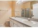 Bathroom showcasing double sinks, vanity, and a shower with glass doors for a clean and modern feel at 11638 Branch Mooring Dr, Tampa, FL 33635