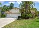 Charming single-story home with lush tropical landscaping and a two-car garage at 11638 Branch Mooring Dr, Tampa, FL 33635