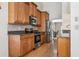 Modern kitchen with stainless steel appliances, granite countertops, and ample cabinet space at 11638 Branch Mooring Dr, Tampa, FL 33635