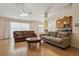 Comfortable living room featuring hardwood floors, a ceiling fan, and ample seating at 11638 Branch Mooring Dr, Tampa, FL 33635