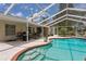 Inviting screened pool with brick trim offers a great outdoor living space for relaxing and entertaining at 11638 Branch Mooring Dr, Tampa, FL 33635