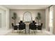 Elegant dining room showcases an oval table, modern black chairs, statement mirror, and stylish décor for sophisticated gatherings at 11982 Brae Way, Dade City, FL 33525